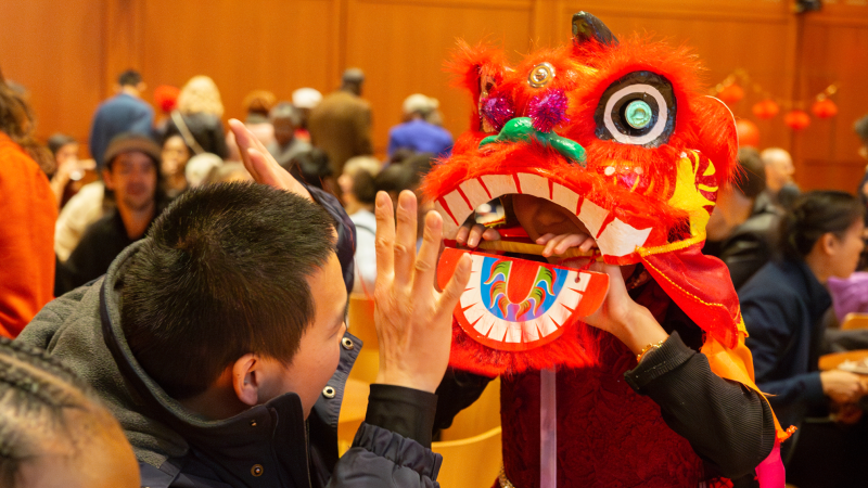 A child wears a lion mask at Trinity's Lunar New Year celebration.