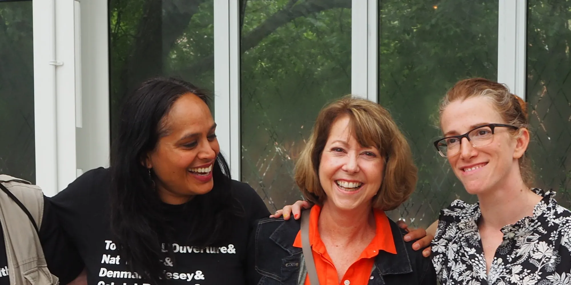 Four staff members smile at our Summer Staff Day