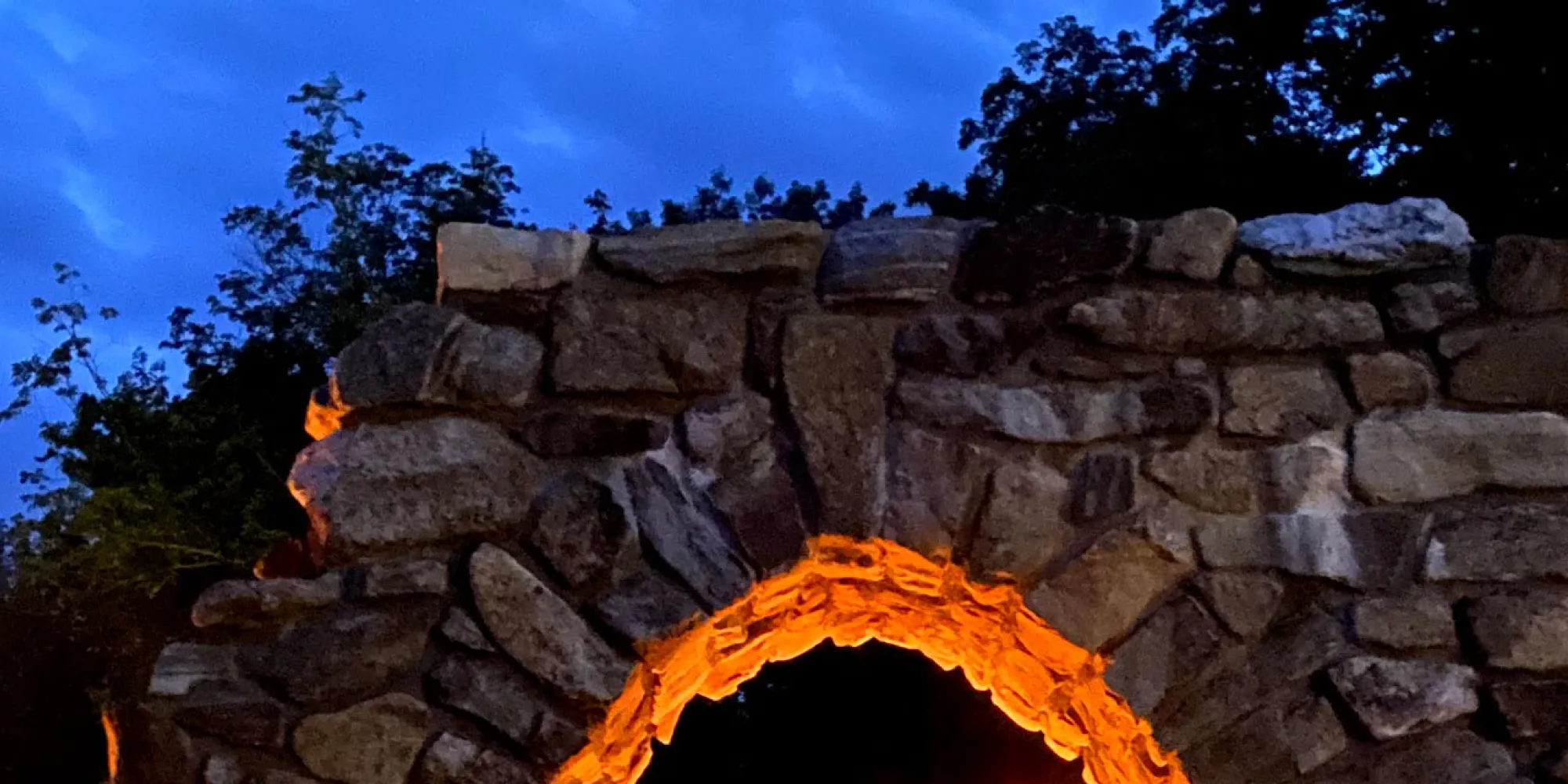 The top of the Retreat Center's stone arch in the early evening