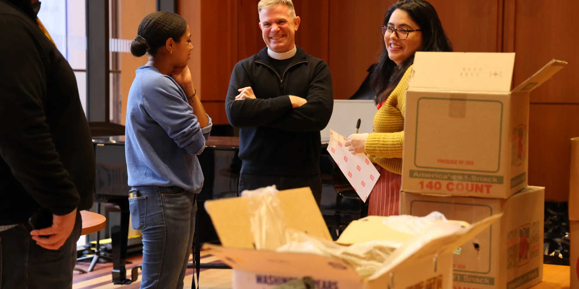 The Vicar and Trinity Outreach staff pack groceries at the Christmas Compassion Market pack.