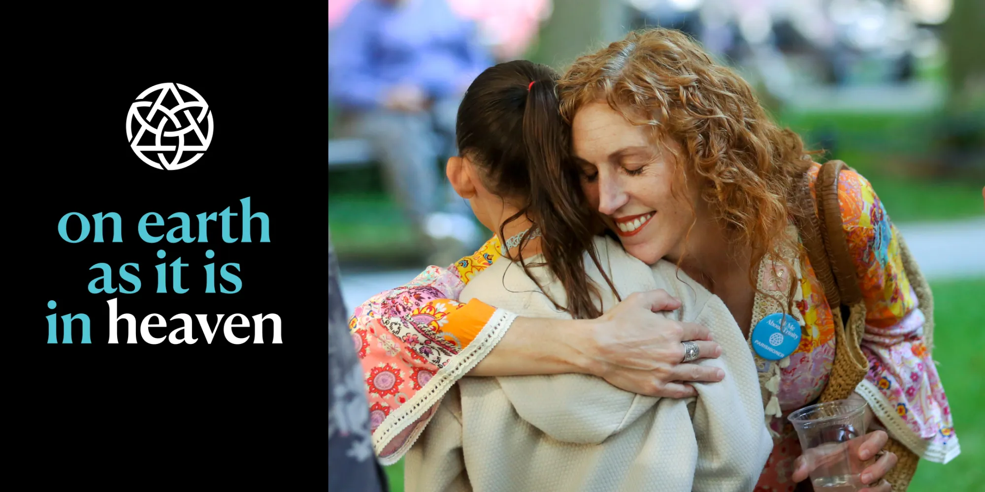 Parishioners hug in the churchyard with the words "on earth as it is in heaven" overlayed