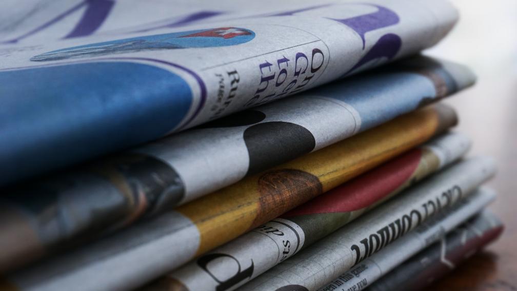 A close up of a stack of newspapers