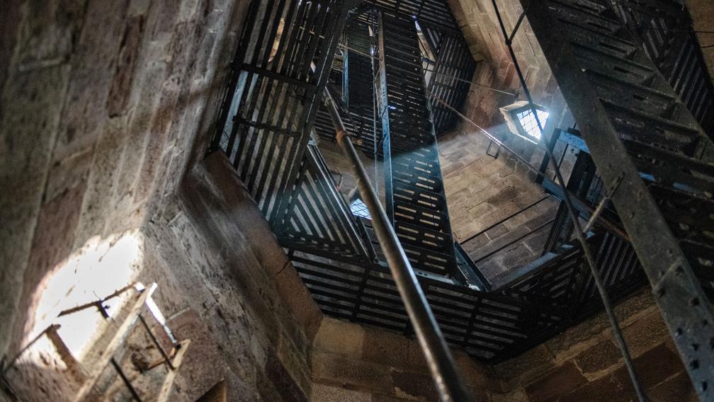 A beam of sunlight shines through a window in the bell tower of Trinity Church Wall Street