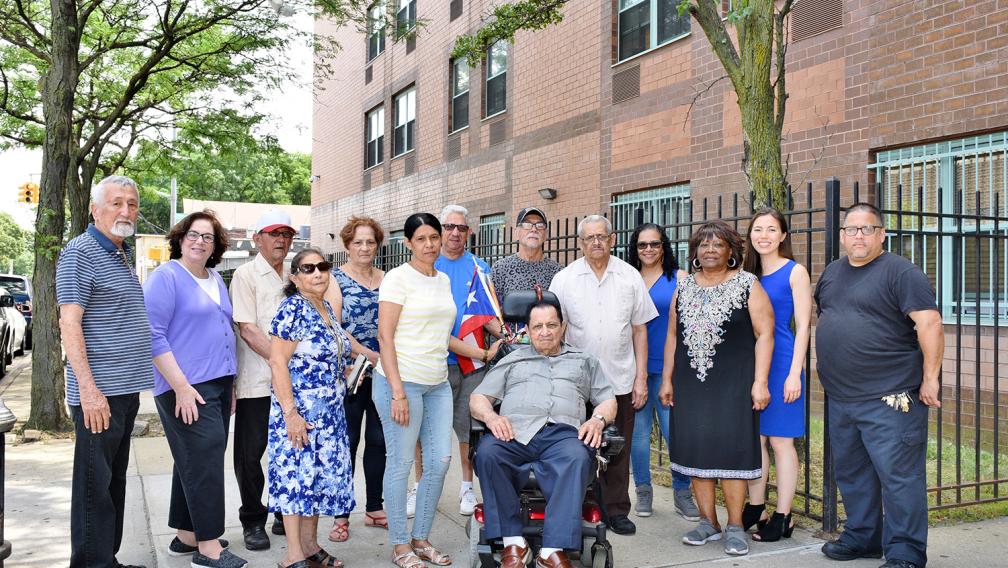 LISC NYC staff stand in front of one of the properties they support.