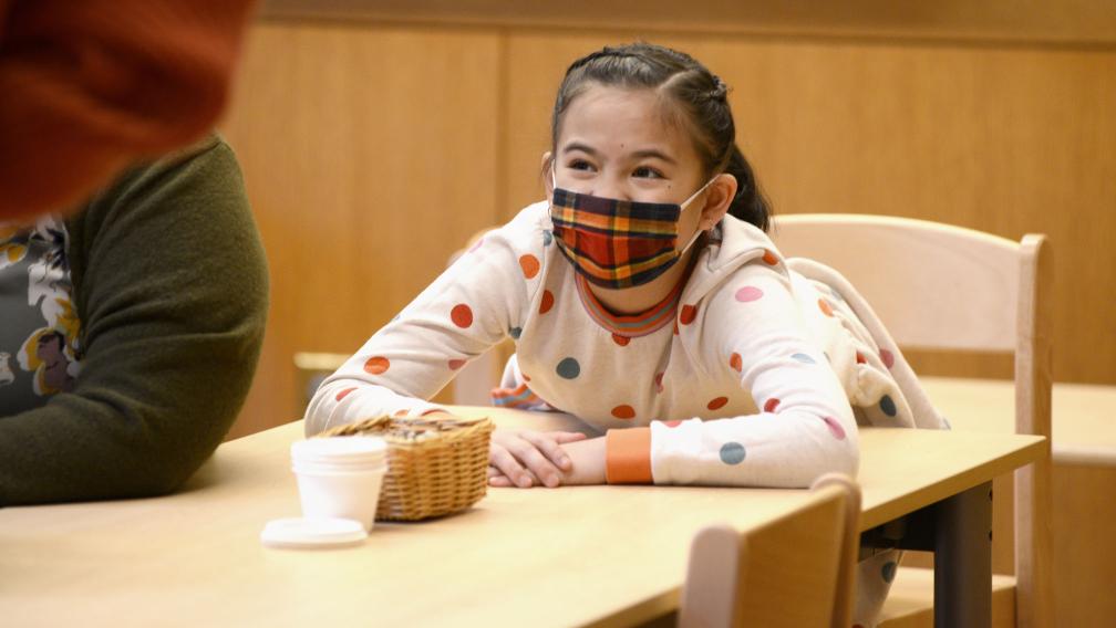 A child smiles during Children’s Time at Trinity Commons