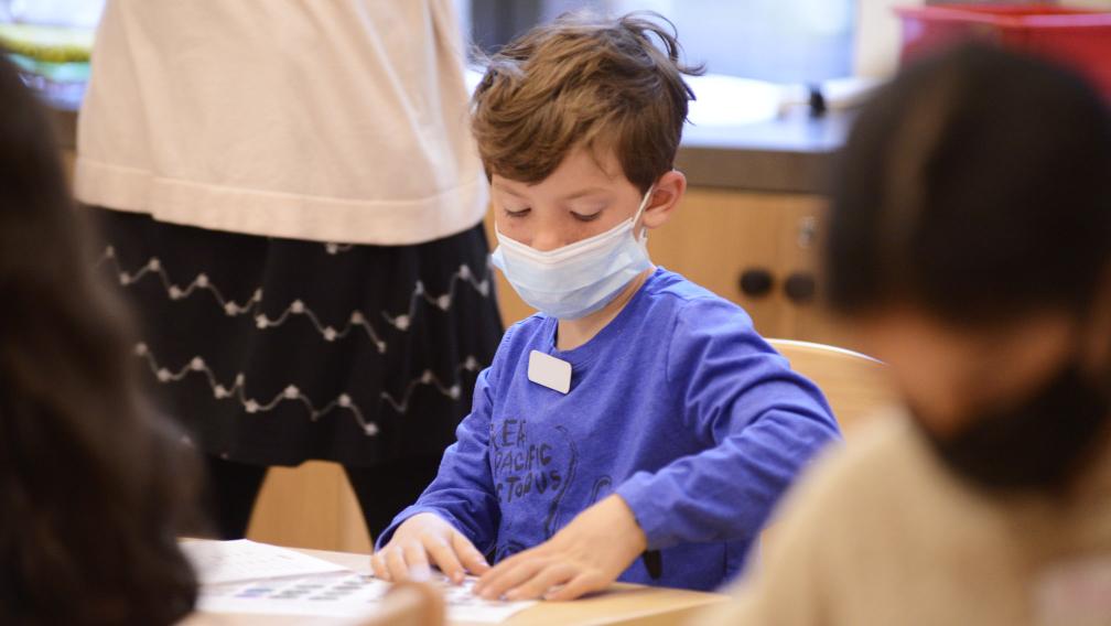 A child working on an activity sheet during Children’s Time