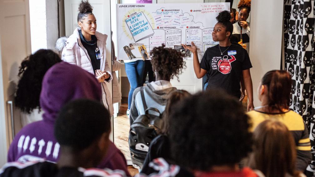 Black girls and LBGTQ+ youth gather in a meeting to discuss a campaign. 