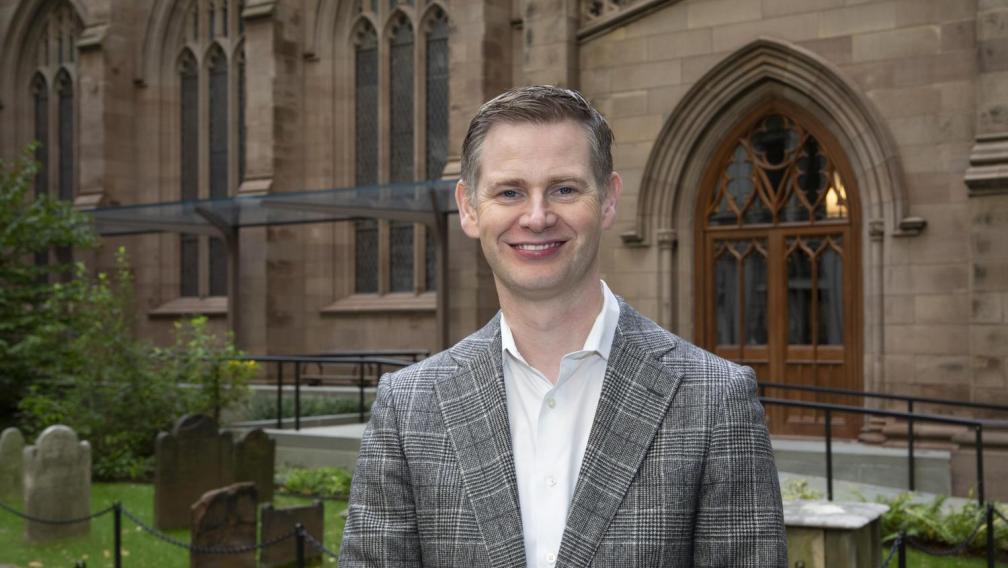 Neill Coleman stands in front of Trinity Church