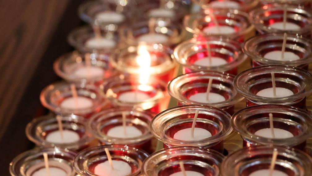 One prayer candle burning among others in Trinity Church