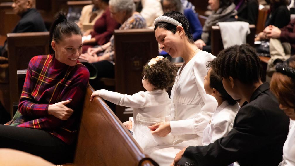 A family with a small child in the pews of Trinity Church