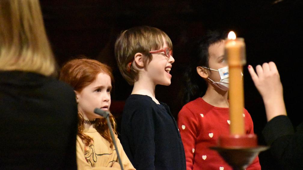 A smiling and singing child during the 9am service at Trinity Church