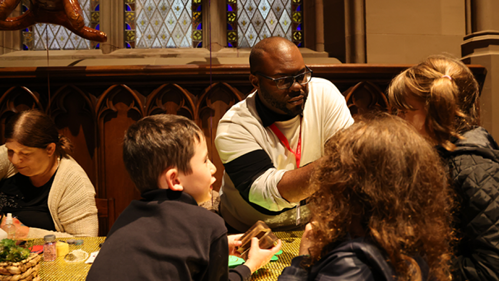 Wayne Edwards works with children at the Blessing of the Animals, 2022