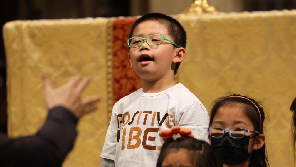 A child sings in Trinity Church during the 9am Holy Eucharist