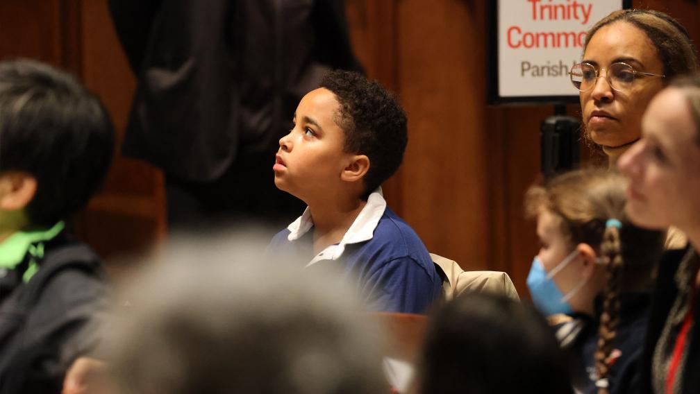 A child sitting in a pew during the 9am service at Trinity Church