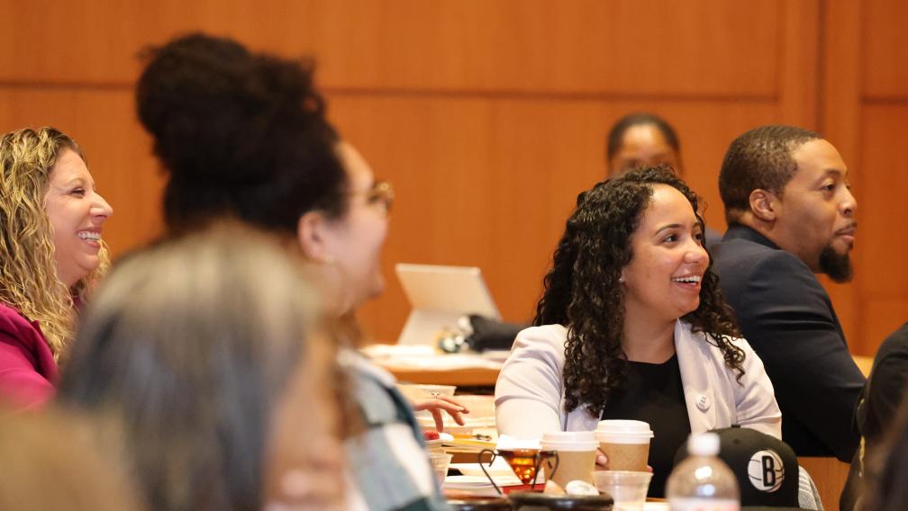 Racial Justice initiative grantees smile while watching a performance by The Peace Poets.