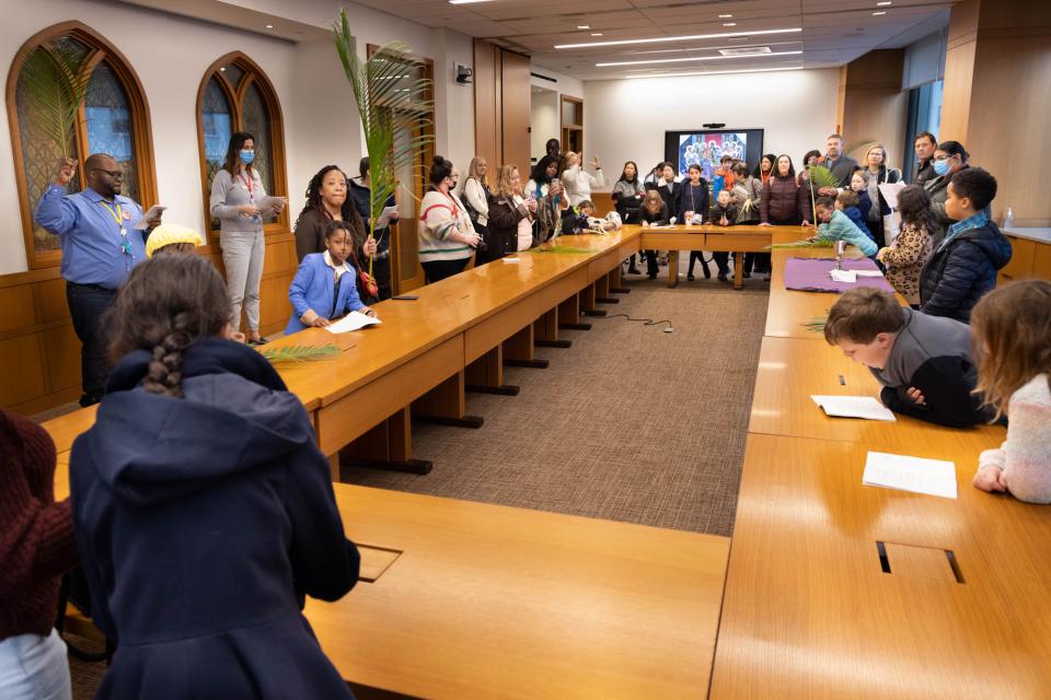 Trinity parishioners and families act out the Last Supper on Palm Sunday.