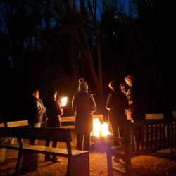 Group warms itself around a fire