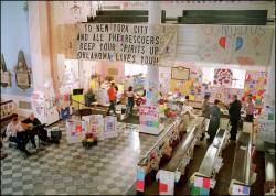 Pews, balcony and walls adorned with banners, flags and cards in honor and memory of volunteers and lives lost at Ground Zero.