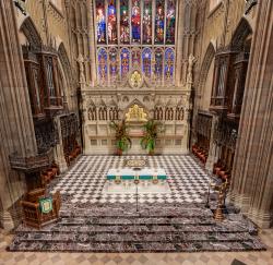 View of the chancel, alter and stained glass window of Trinity Church.