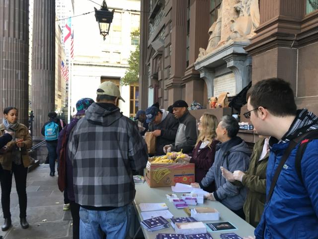 People lining up to get brown bags.