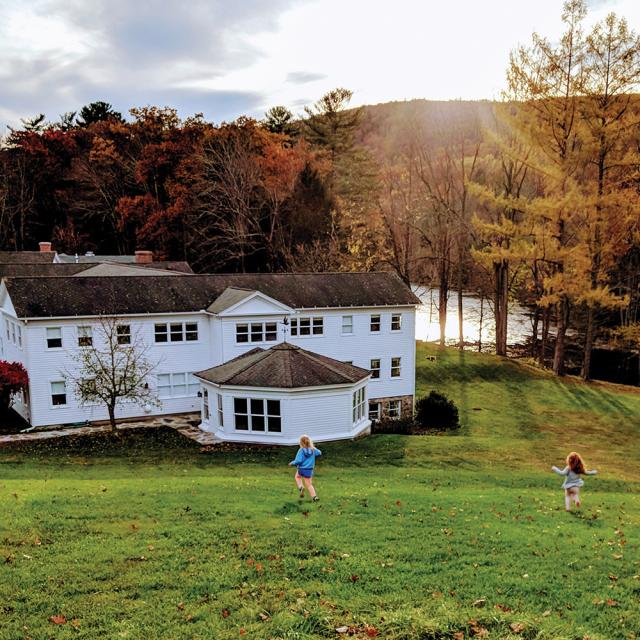 Two children running down a hill