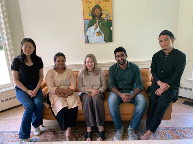 Trinity Union Fellows cohort 3 sits on a yellow couch in front of an icon of Jesus.