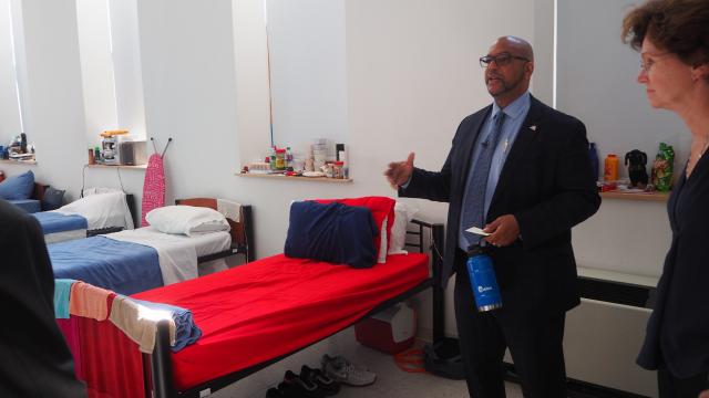 Stanley Richards looks to a man off-camera. He's giving a tour of a room inside Castle Gardens, a supportive housing facility run by the Fortune Society. 