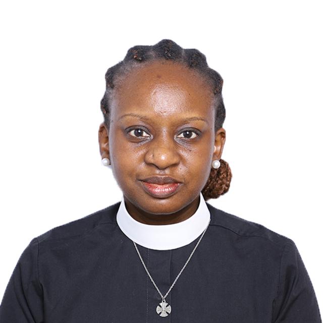 Rose Mpango looks at the camera with a slight smile, wearing a priest's collar and silver cross pendant.