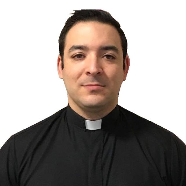 Manuel Borbon faces the camera with a slight smile, wearing clergy attire.