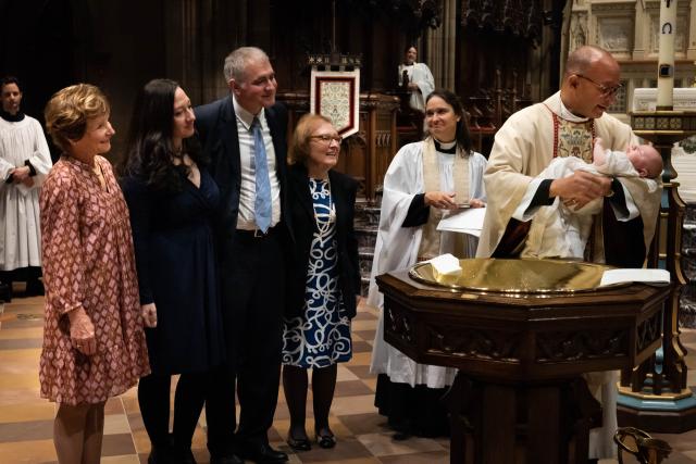 The Rev. Phil Jackson baptizes sleeping baby