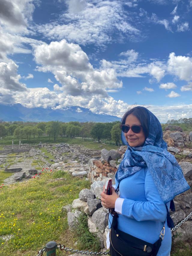 Woman stands in front of field