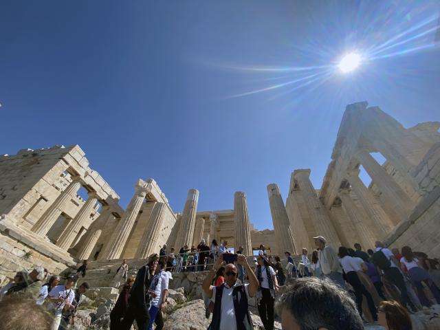 A view of the columns of an ancient building from the bottom of the steps