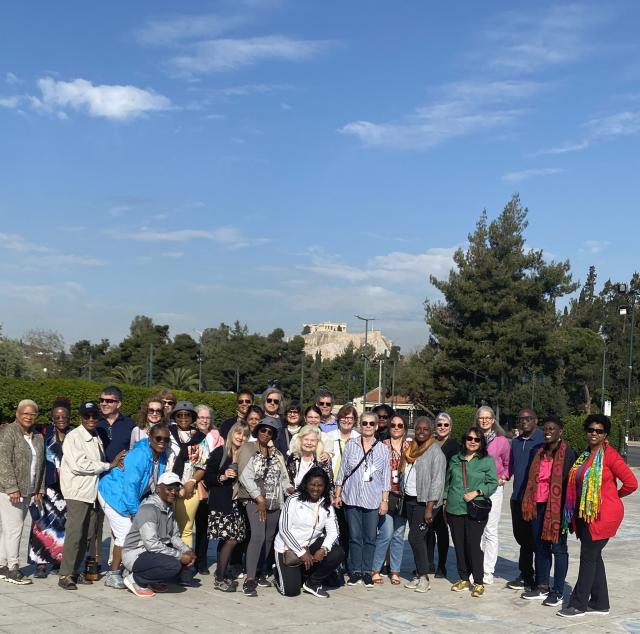 Group of people with ancient building far in the background