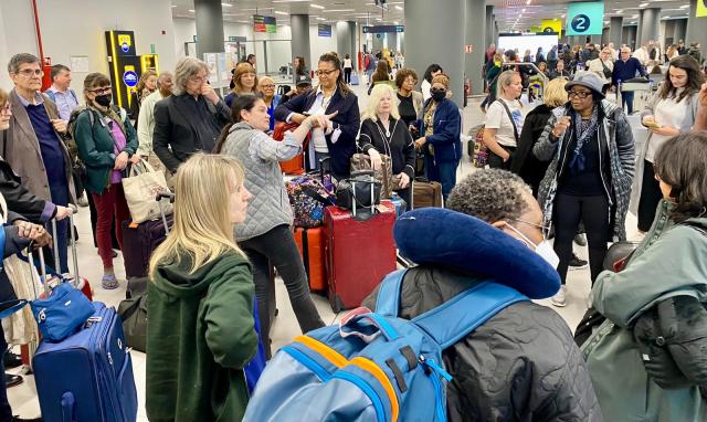 A group of people stand together in an airport