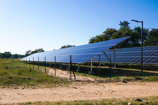 A wide shot of the 152-kilowatt solar farm consisting of approximately 360 panels, batteries, and a transformer. 