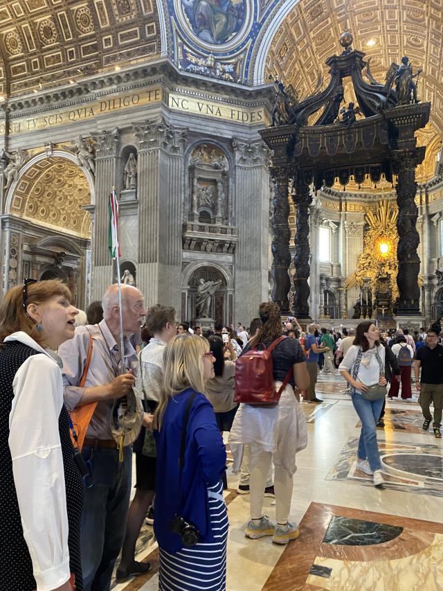 Group stands in church looking at architectural features