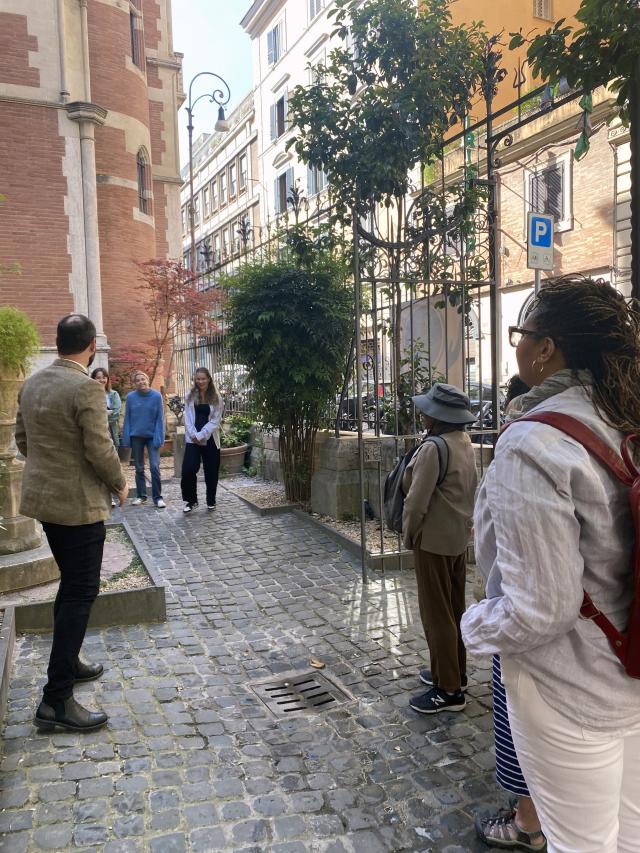 People stand in the courtyard outside a church