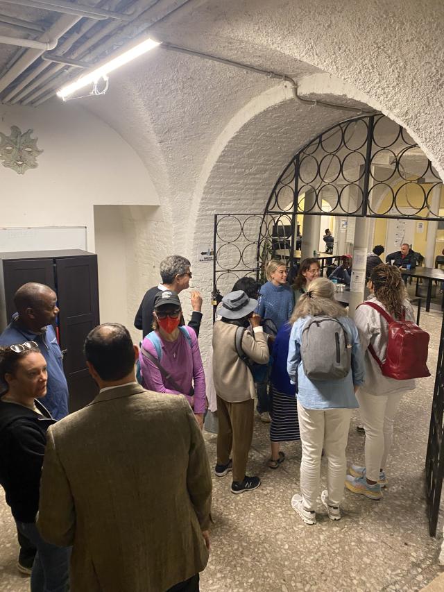 People stand outside the gates of an underground room