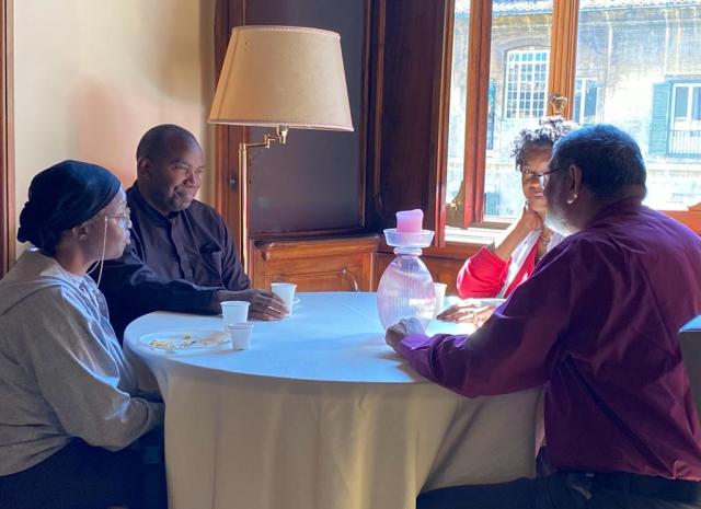 People sit together around a table