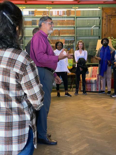 Man talks to group of people standing around him