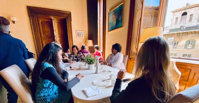 People around a table eat together