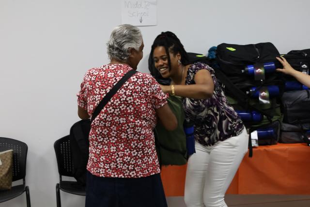 Family member picks up backpack at The Loisaida Center