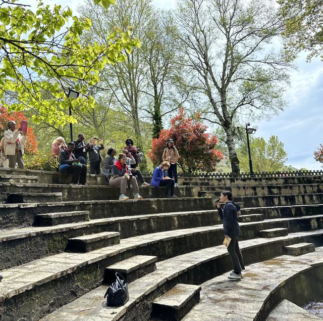 Summerlee Staten teaches before a crowd in an outdoor amphitheater in Philippi, Greece