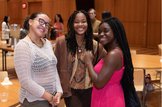 Three Trinity Youth members hang out in the parish hall. 