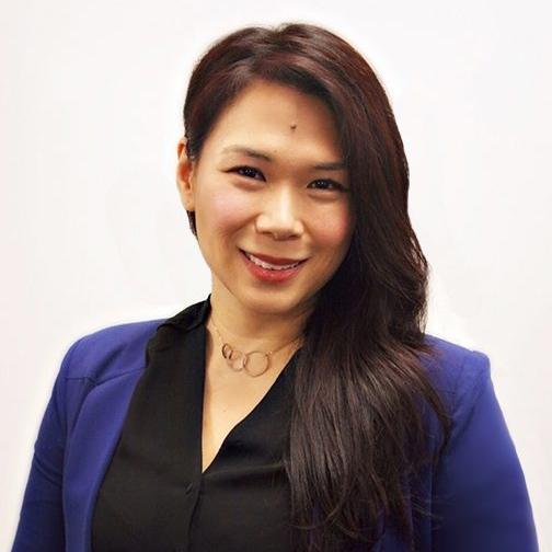 Eva Wong wears a blue blazer over a black blouse and gold necklace.