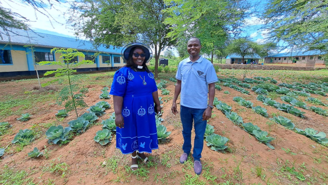 The Reverend Wendy Mwangi and the Venerable Johnson Mutuota in front of the garden at the Guardian Academy (Kenya) Photo credit: Episcopal Relief & Development staff