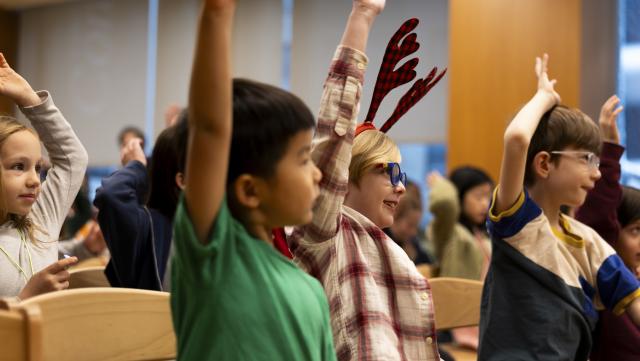 Kids raising their hands.