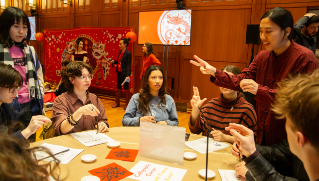 Youth learn calligraphy at Trinity's Lunar New Year celebration.