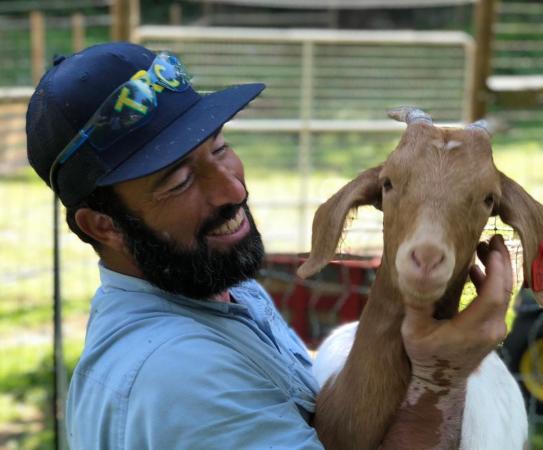 Ashraf holds Ginny the goat