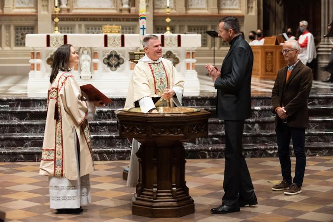 A man is baptized in Trinity Church on All Saints Sunday 2021